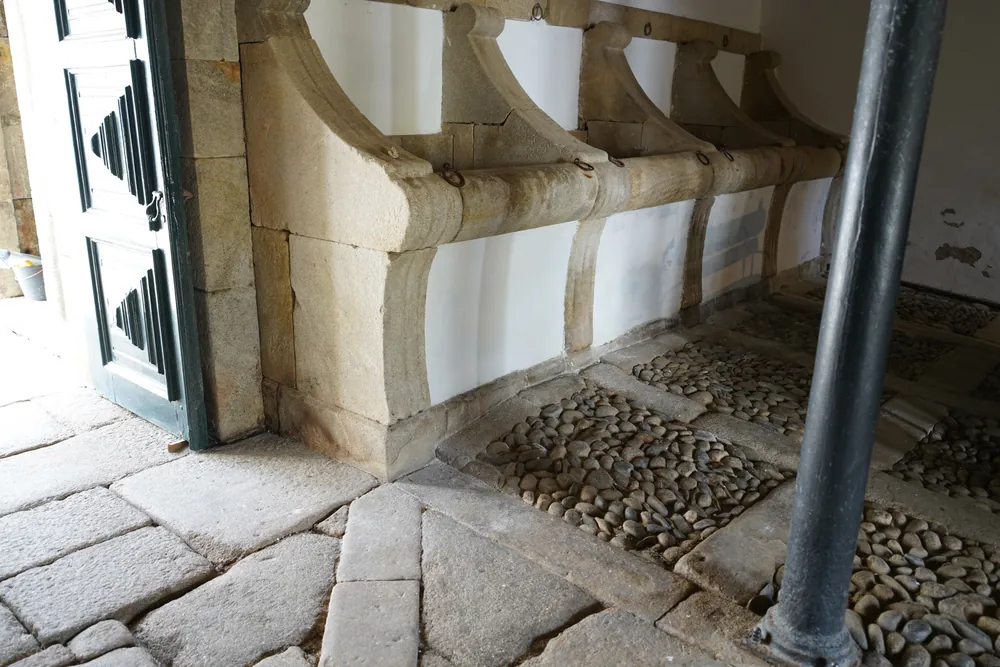 Ground floor: the stone mangers of the former stables.