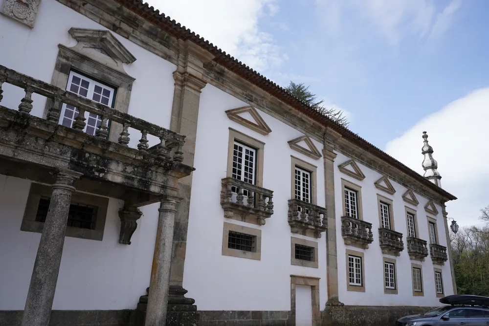 North front, with the stone balcony on four Tuscan columns.